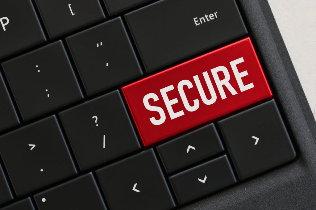 Concept - Computer Keyboard with red key that says SECURE, security password protected locked